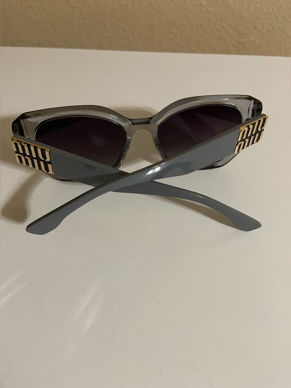 Miu Miu Gray Cat-Eye Sunglasses with Gold Logo Temples
